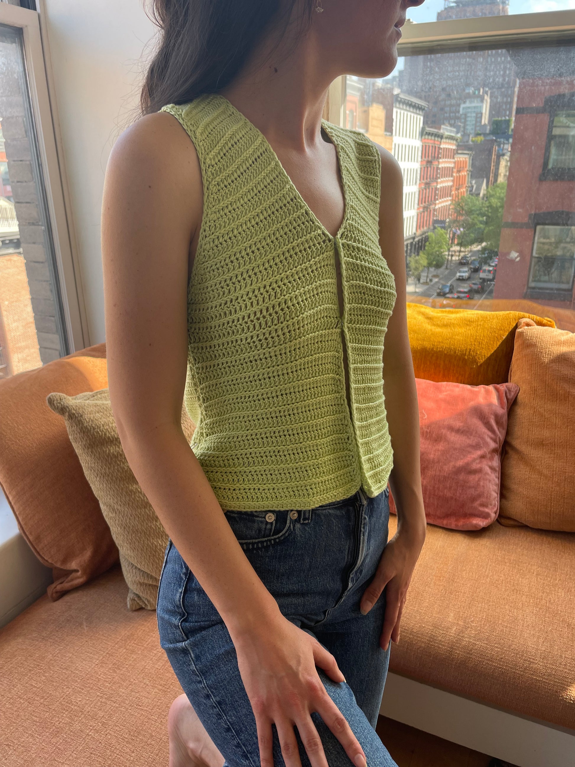 Model wearing the Surena Crochet Nena vest crochet pattern in lime green