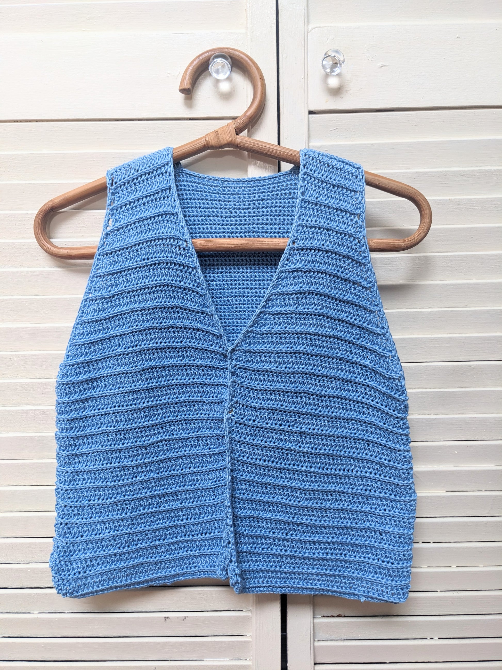 Detail of the surena crochet nena vest crochet pattern in baby blue, perfect for intermediate beginners