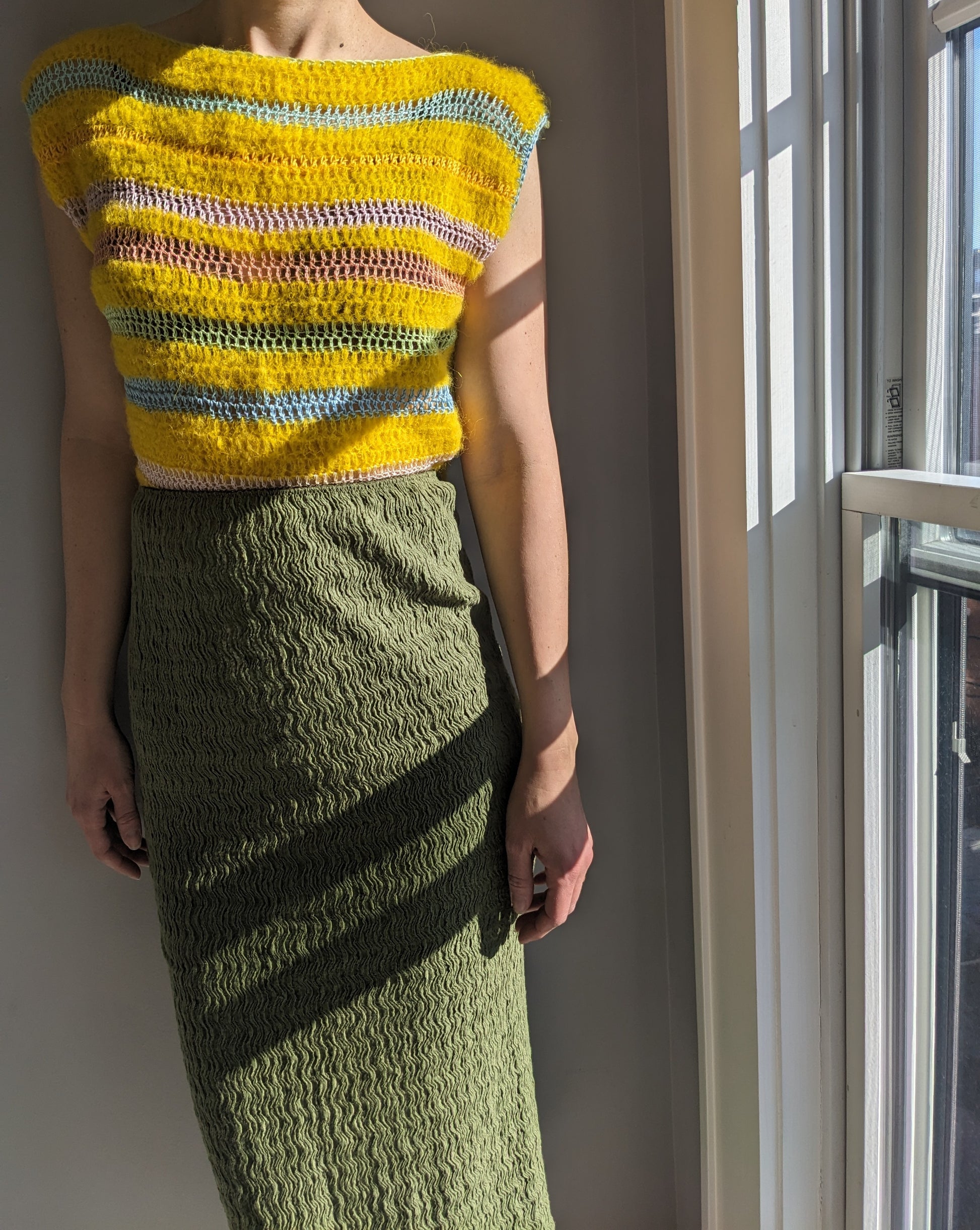 Model wearing the Surena crochet cloud top in yellow