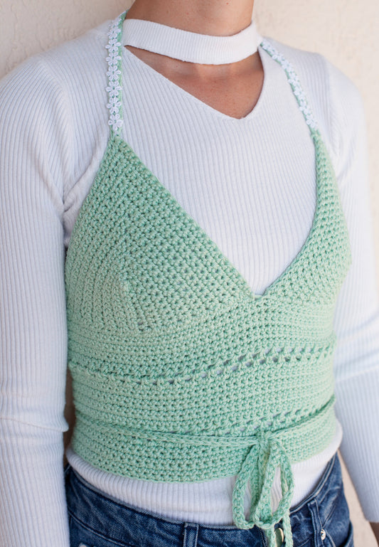 Model wearing the surena crochet margarita top in mint green, a handmade crochet top custom made with cotton yarn.