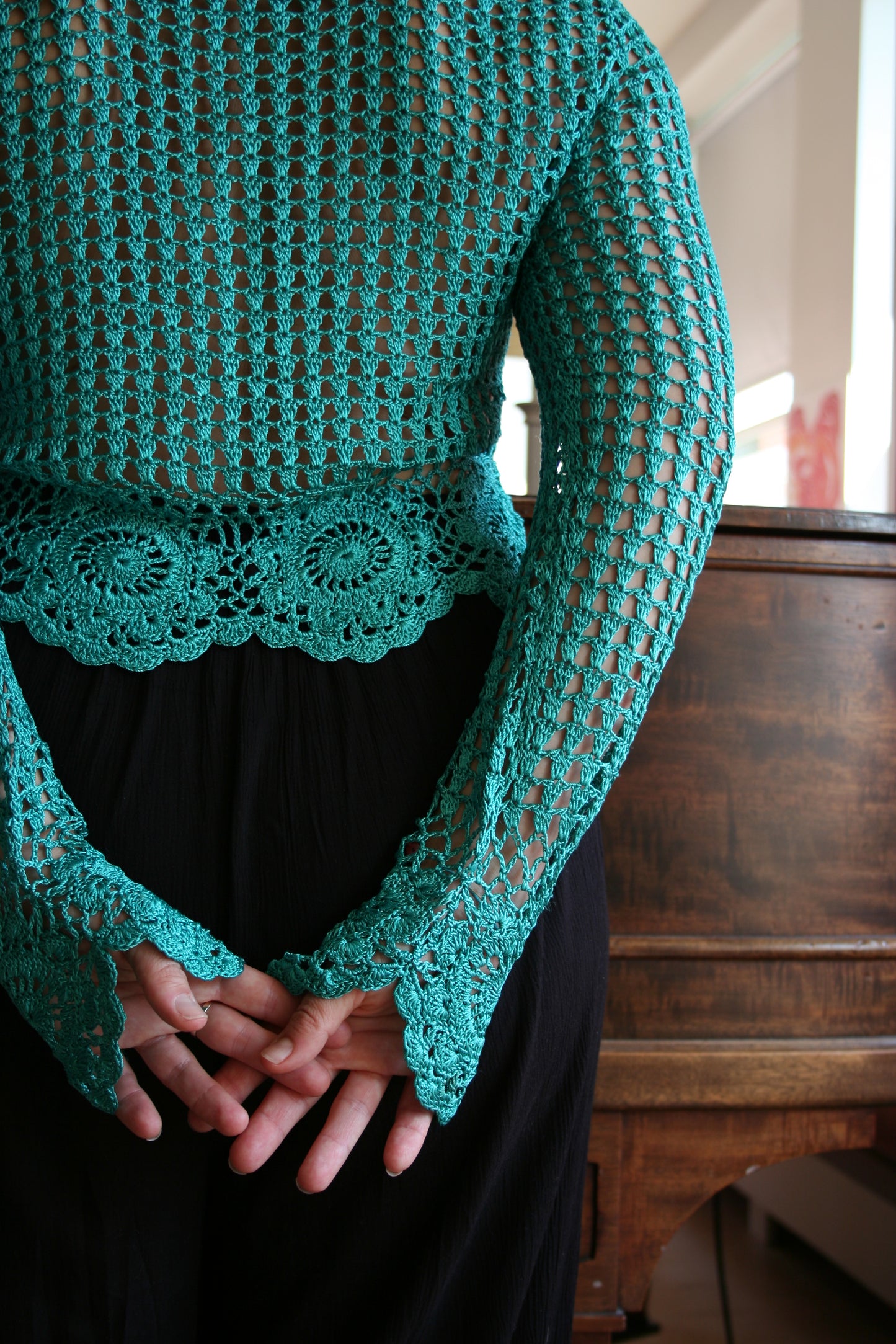 Back of the boho turquoise crochet vest, as worn by the model