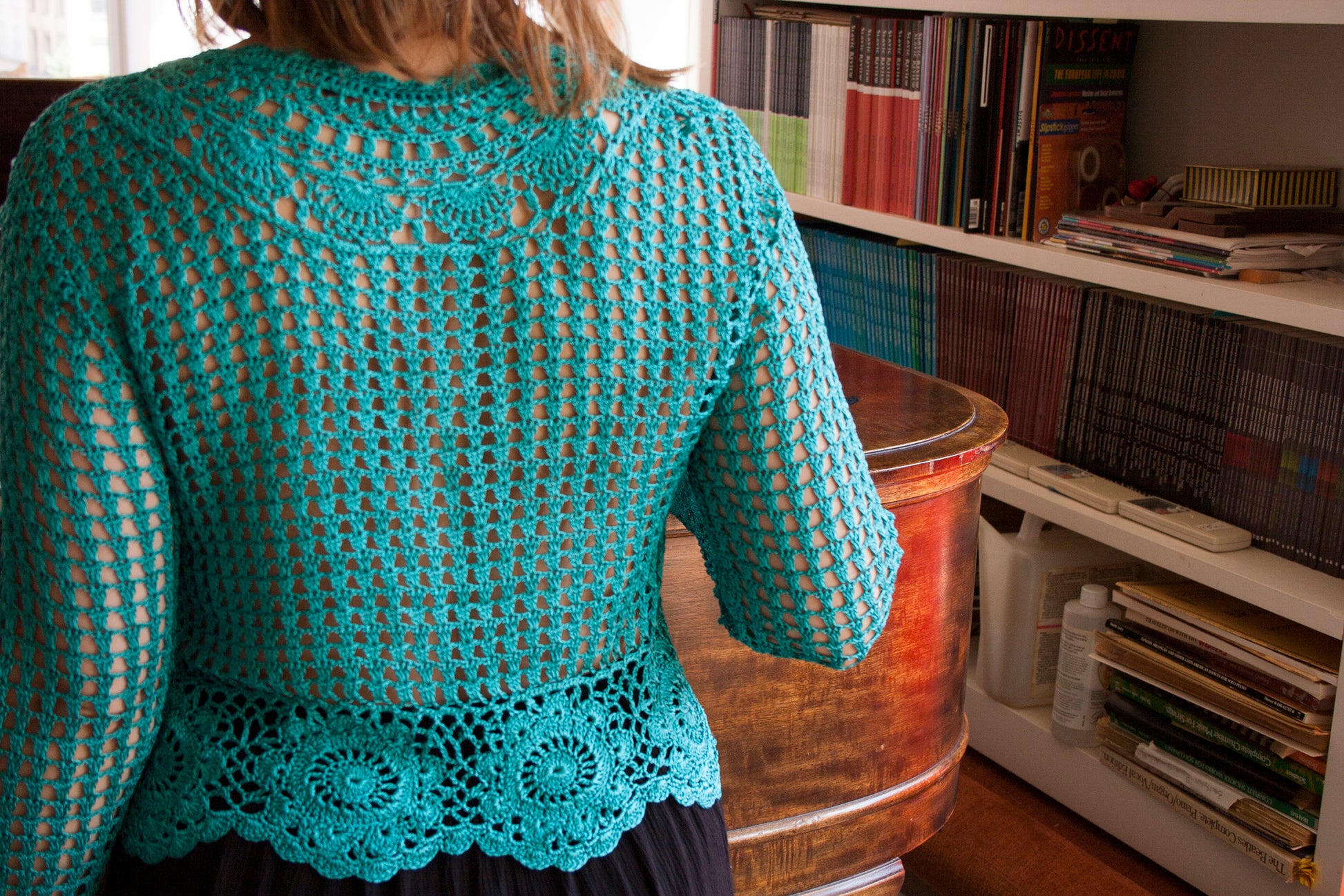 Back of the boho turquoise crochet vest, as worn by the model