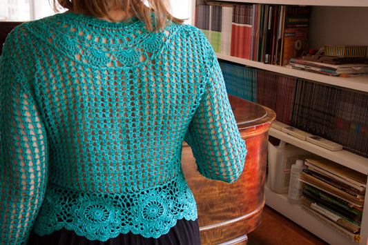 Back of the boho turquoise crochet vest, as worn by the model