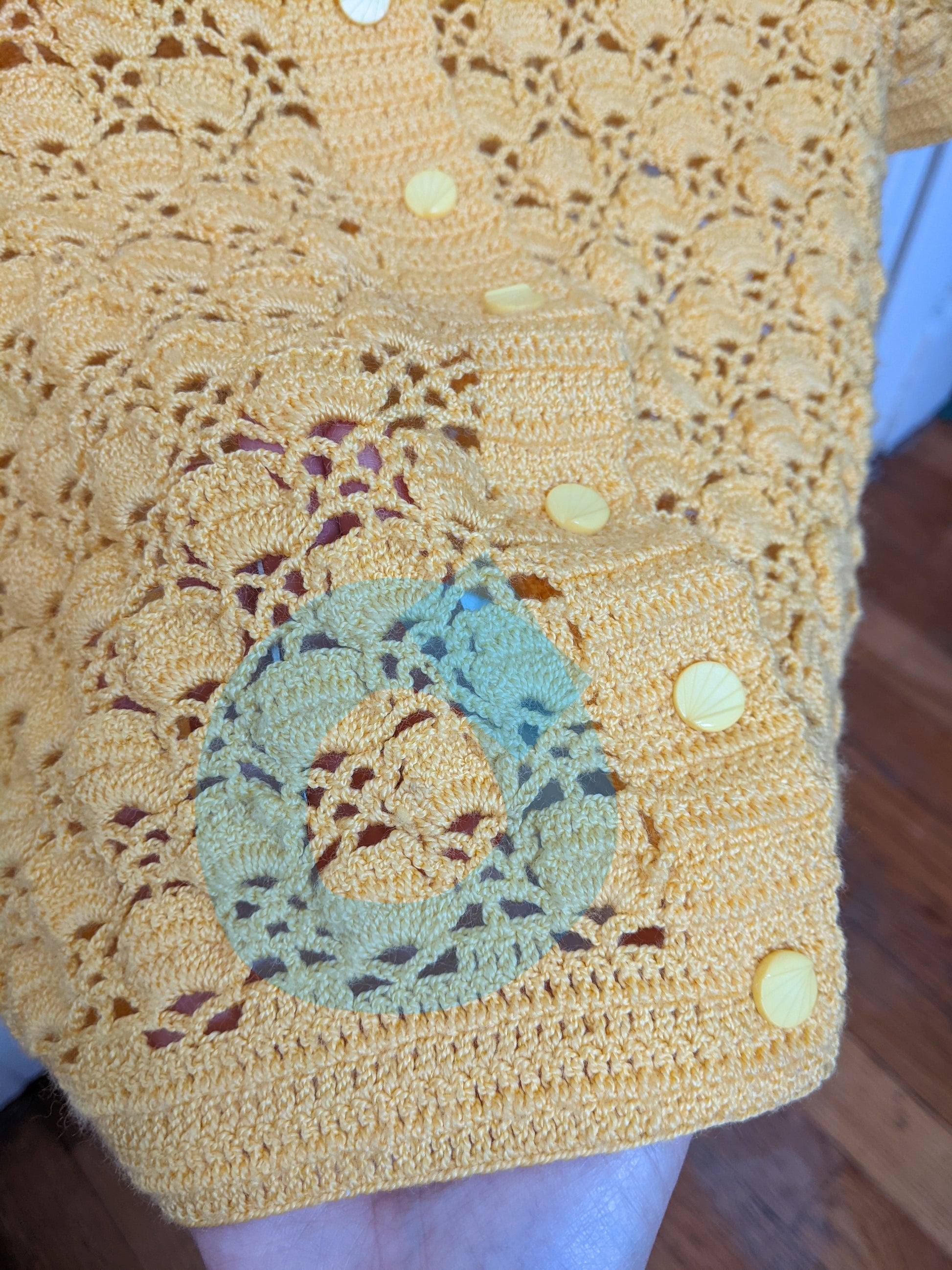 Detail of the small blemish on the Surena crochet "preloved" collection Sunshine yellow cardgian