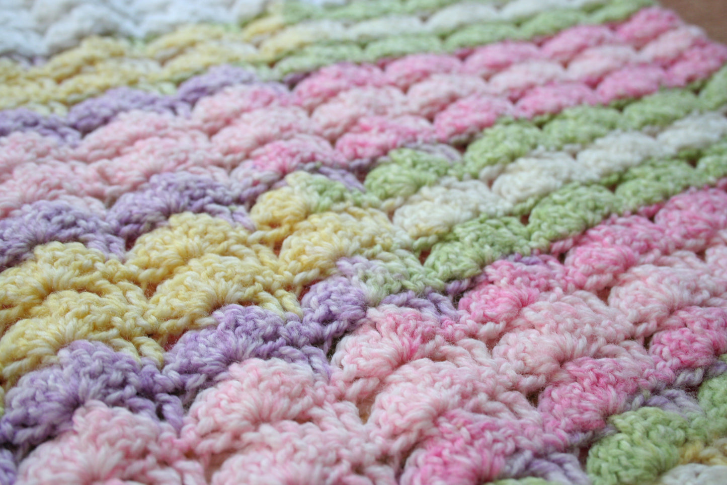 Detail of the crochet stitch pattern in the preloved pastel rainbow mini top