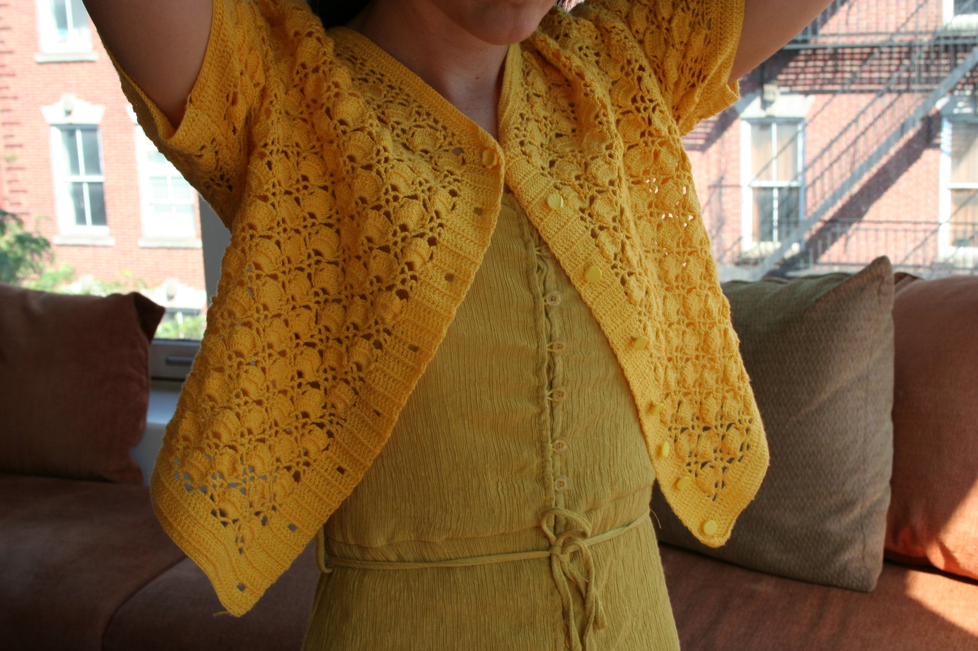 Model wearing the sunshine yellow crochet cardigan.