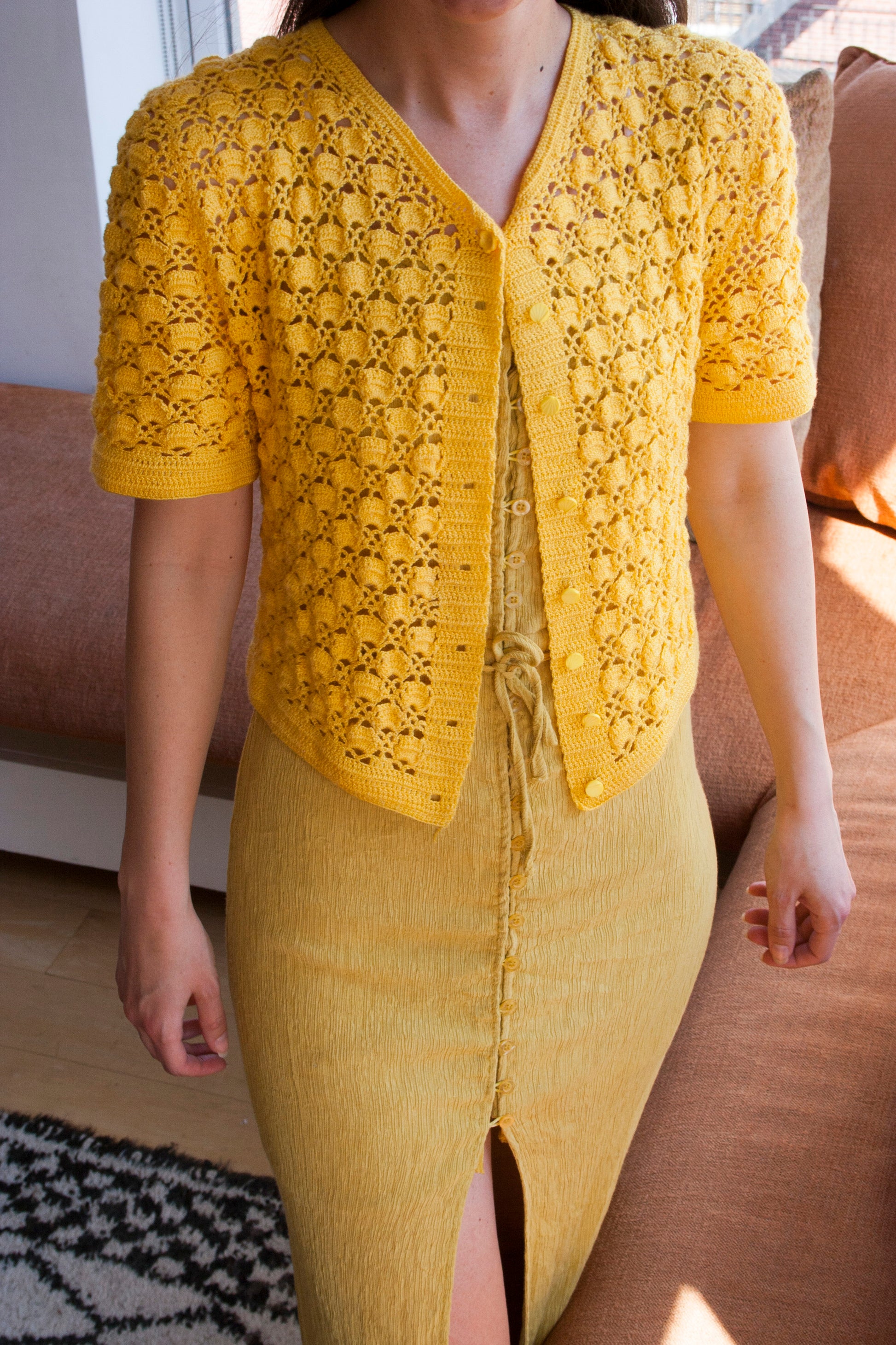 Model wearing the sunshine yellow crochet cardigan.