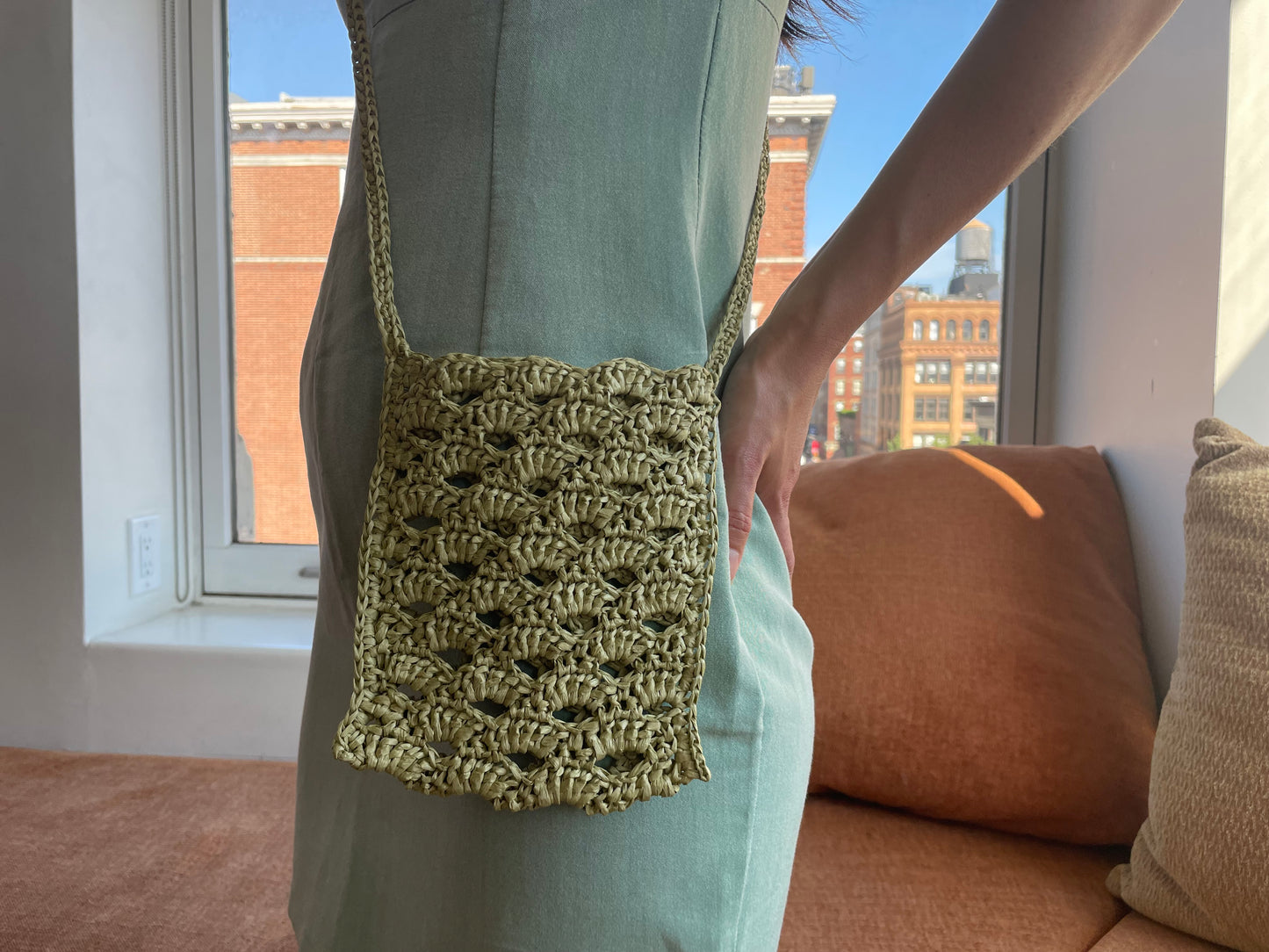 Model wearing surena crochet crossbody raffia bag