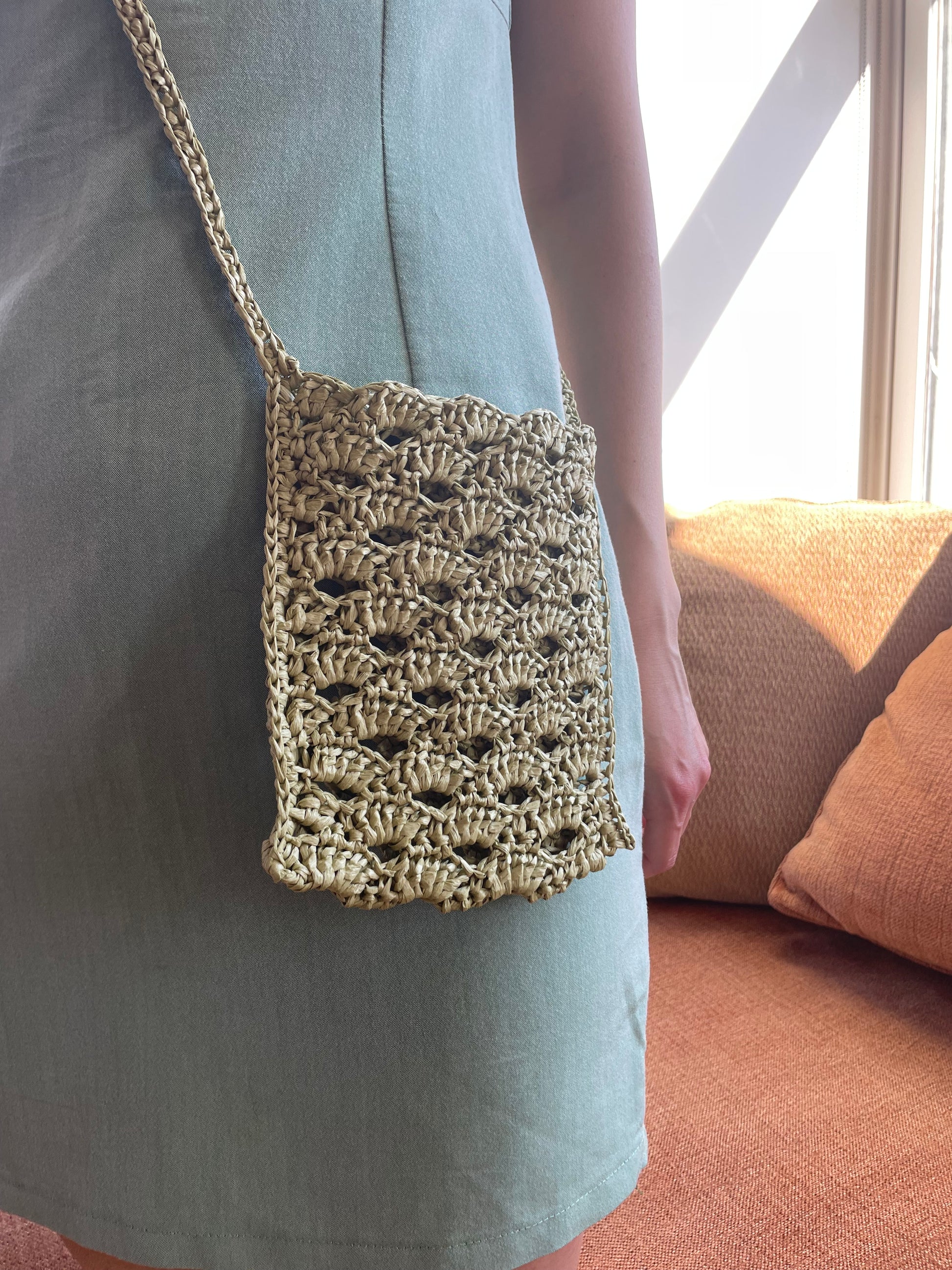 Model wearing surena crochet crossbody raffia bag