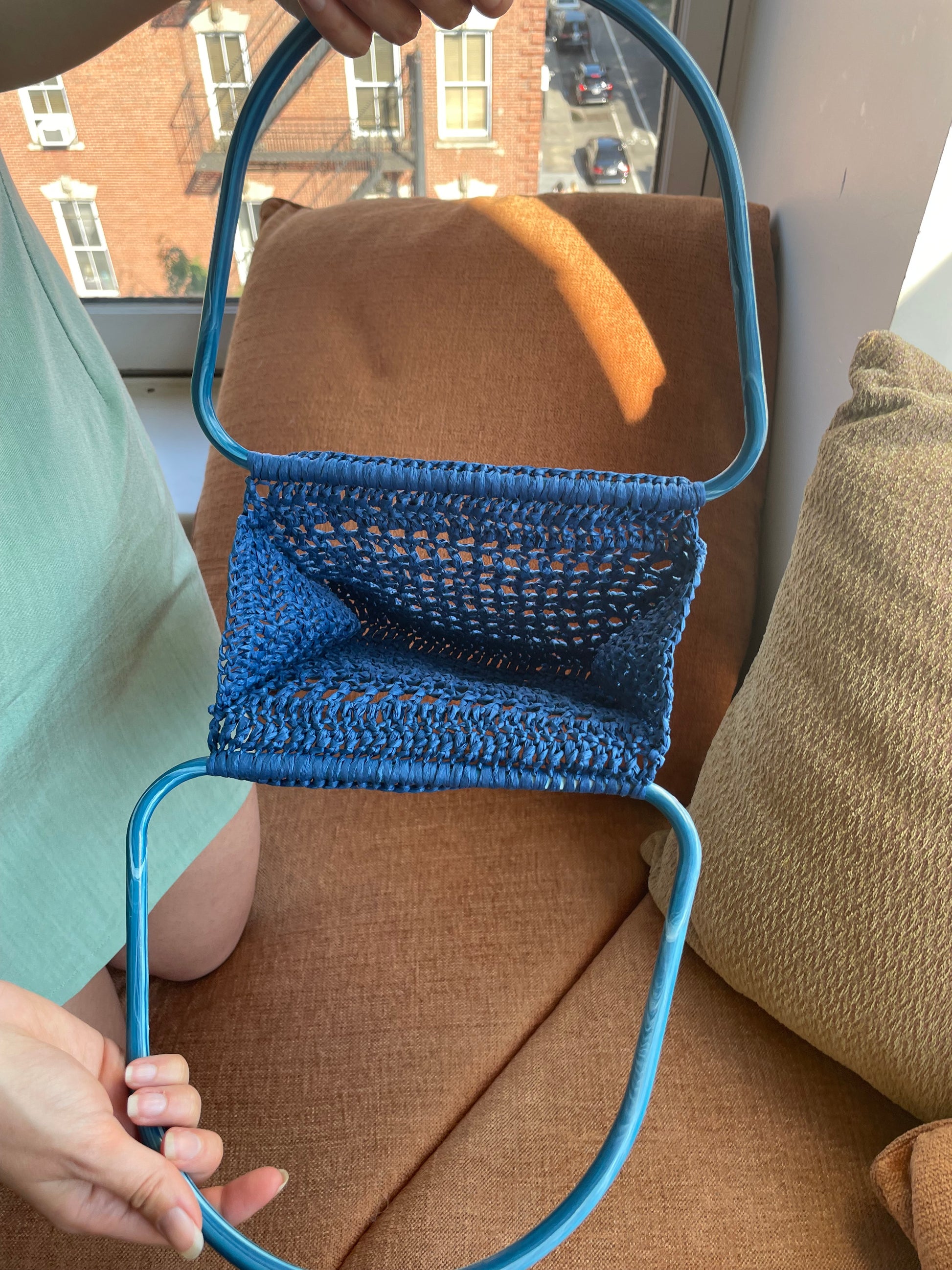 Model showing the inside of the blue market raffia bag