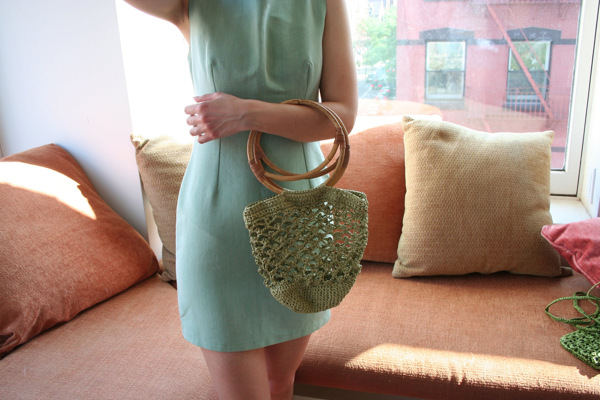 Model wearing the piña raffia bag in green