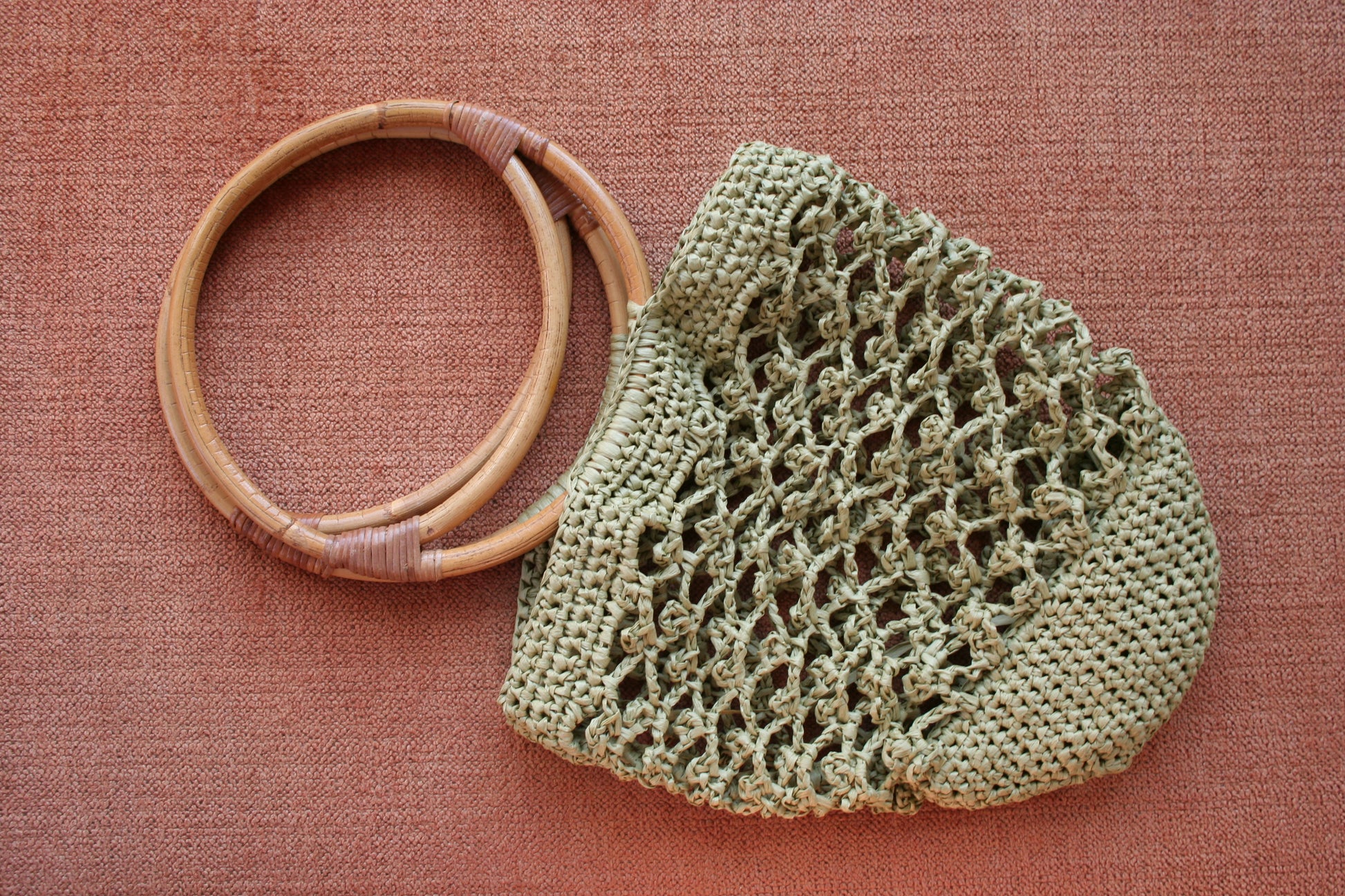 Piña raffia bag in green laid flat