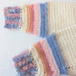 Detail of the sleeves of the Sunrise crochet sweater, perfect for winter