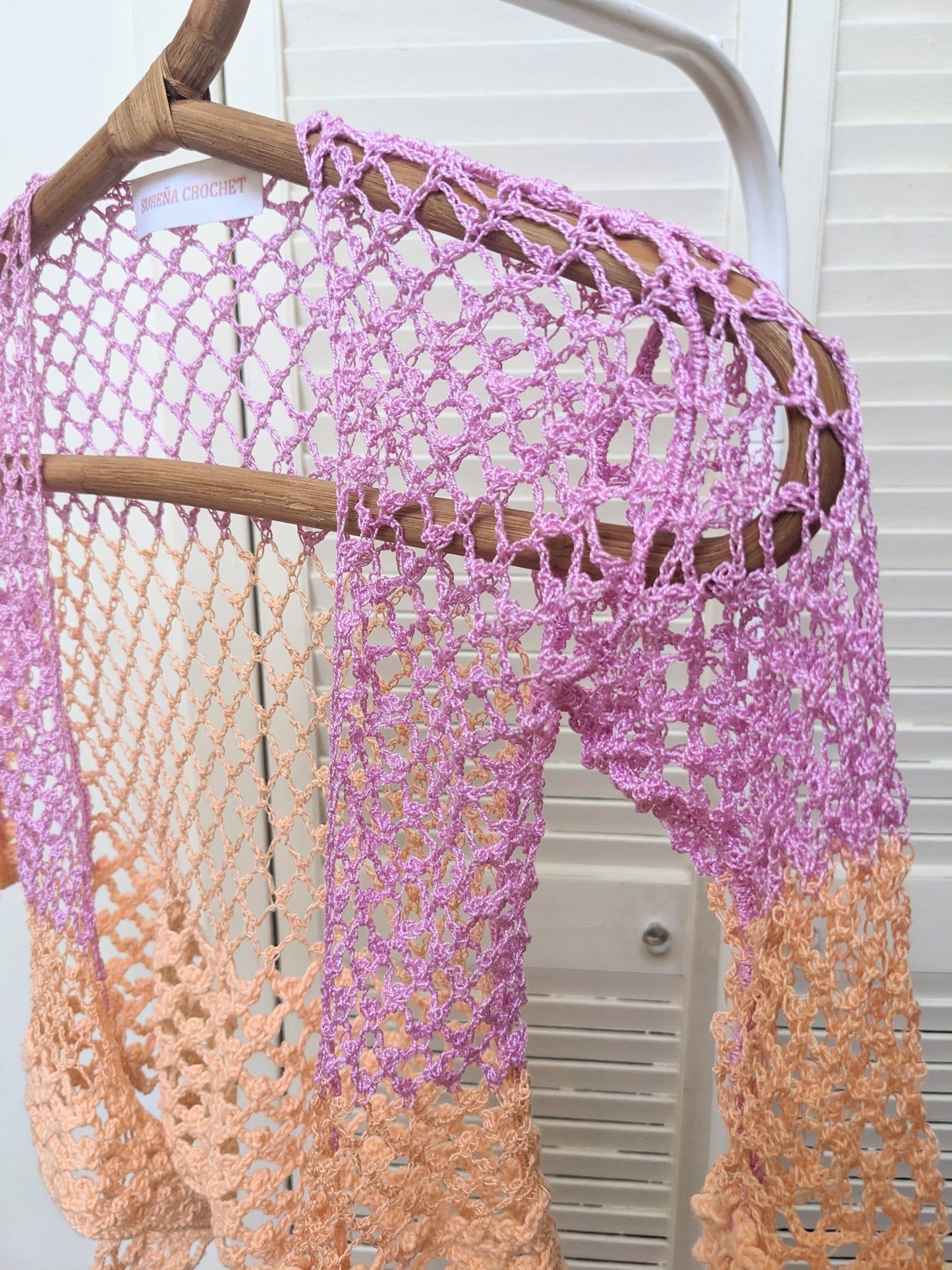 Detail of the Surena crochet sirena crochet top in "dawn" purple and salmon