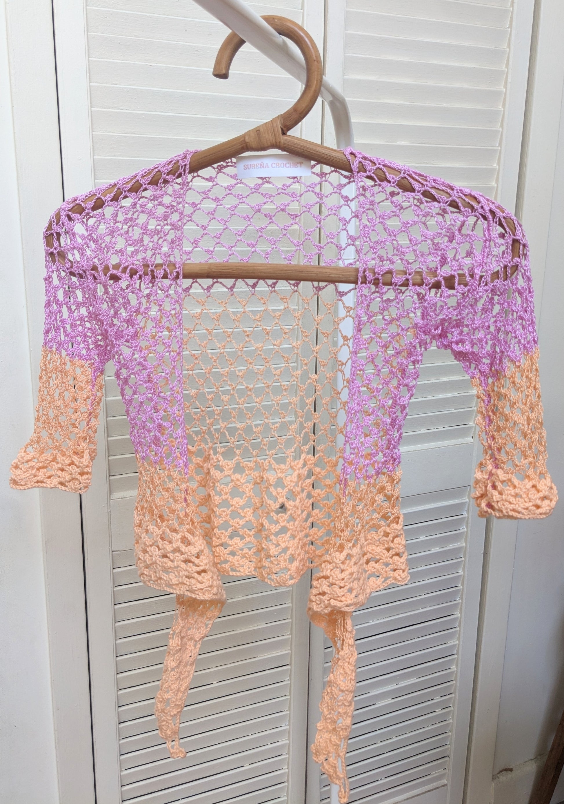 Detail of the Surena crochet sirena crochet top in "dawn" purple and salmon