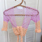 Detail of the Surena Crochet sirena crochet top in "dawn" purple and salmon