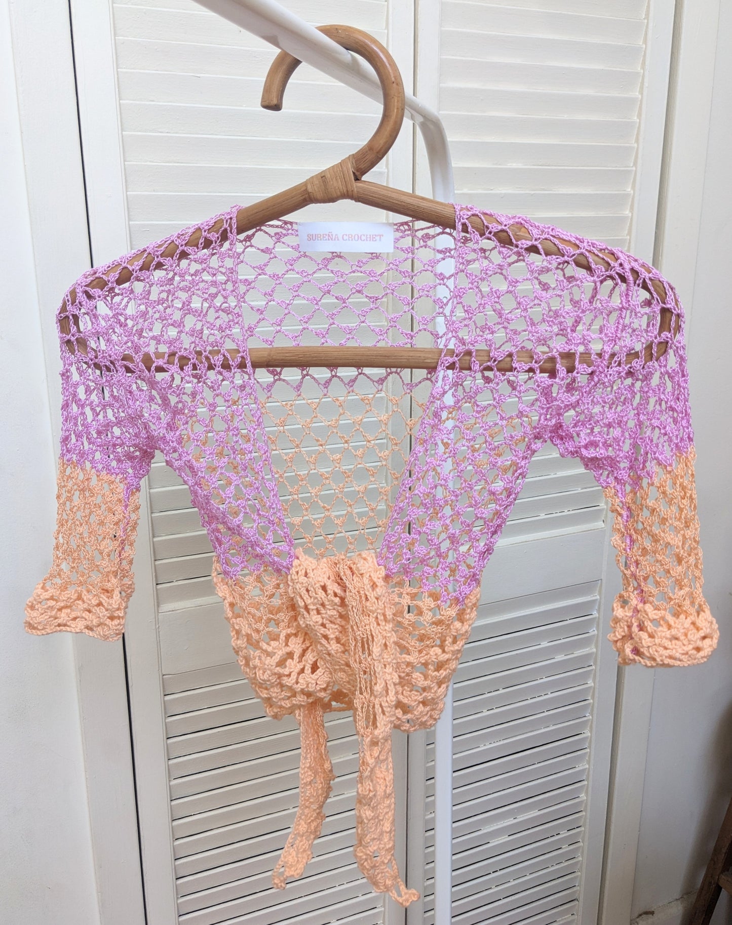 Detail of the Surena Crochet sirena crochet top in "dawn" purple and salmon