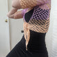 Model wearing the Surena Crochet Sirena top in "dawn" purple and salmon 