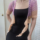 Model wearing the Surena Crochet sirena crochet top in "dawn" purple and salmon