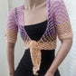 Model wearing the Surena Crochet sirena crochet top in "dawn" purple and salmon