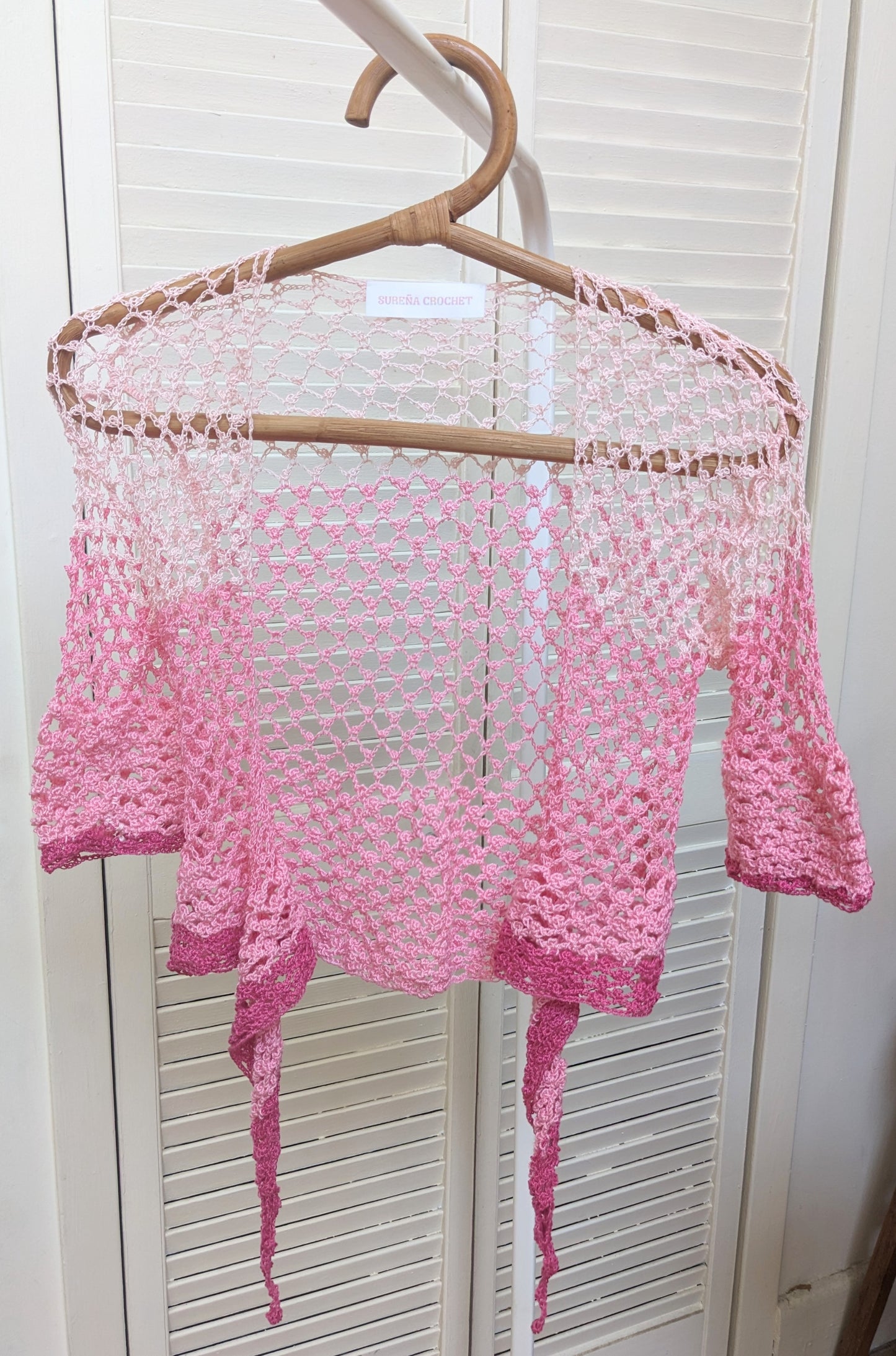 Detail of the Surena Crochet sirena crochet top in "kiss" pink color palette