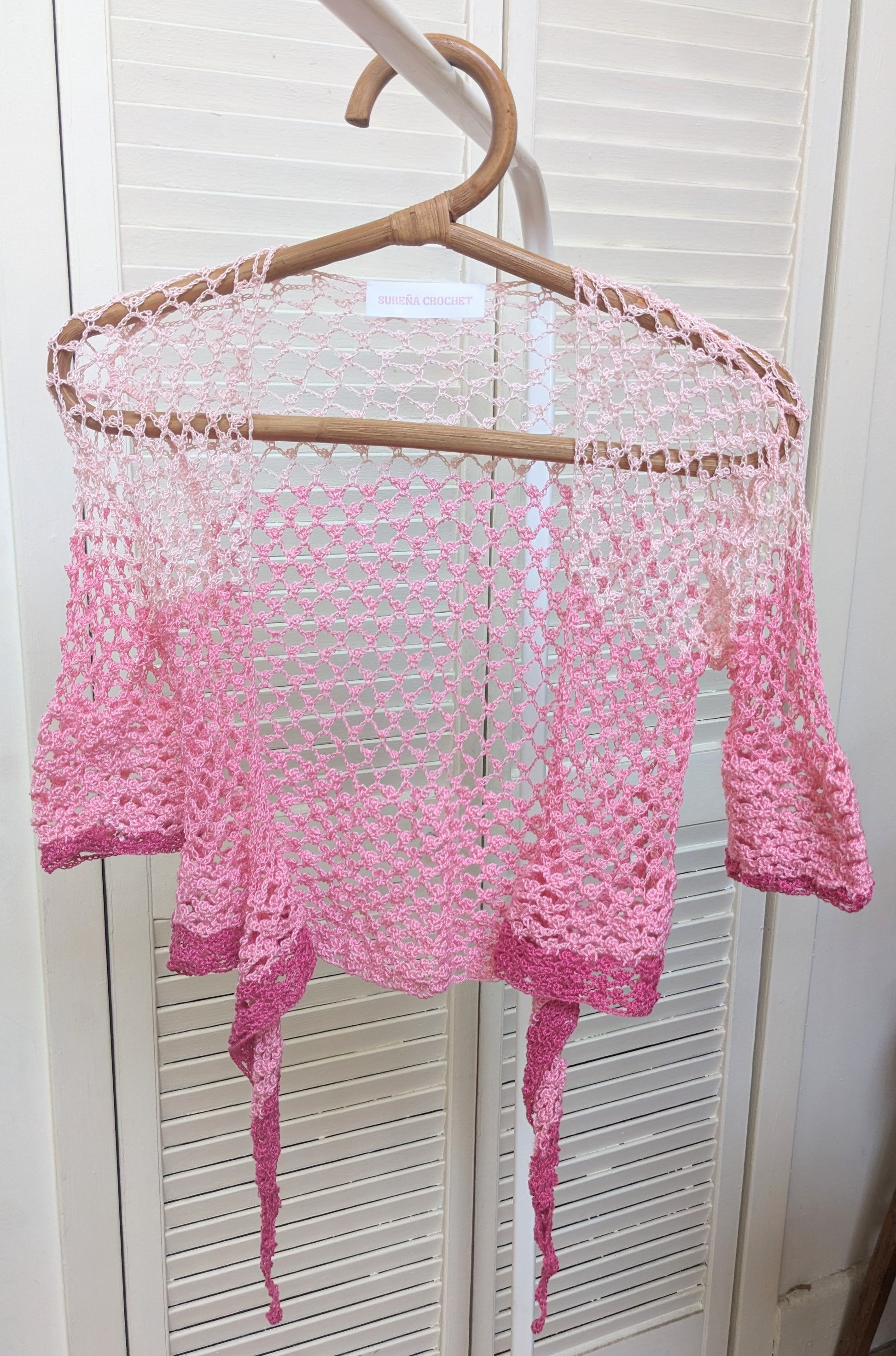 Detail of the Surena Crochet sirena crochet top in "kiss" pink color palette