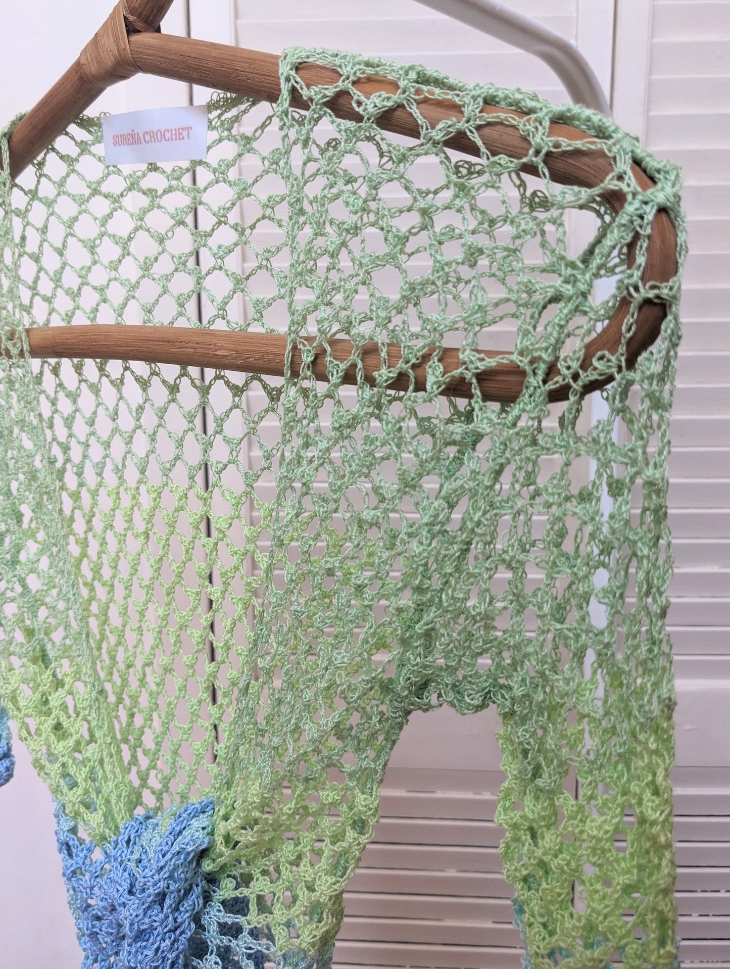 Detail of the Surena crochet sirena crochet top in "ocean" blue and green color palette, handmade with cotton yarn