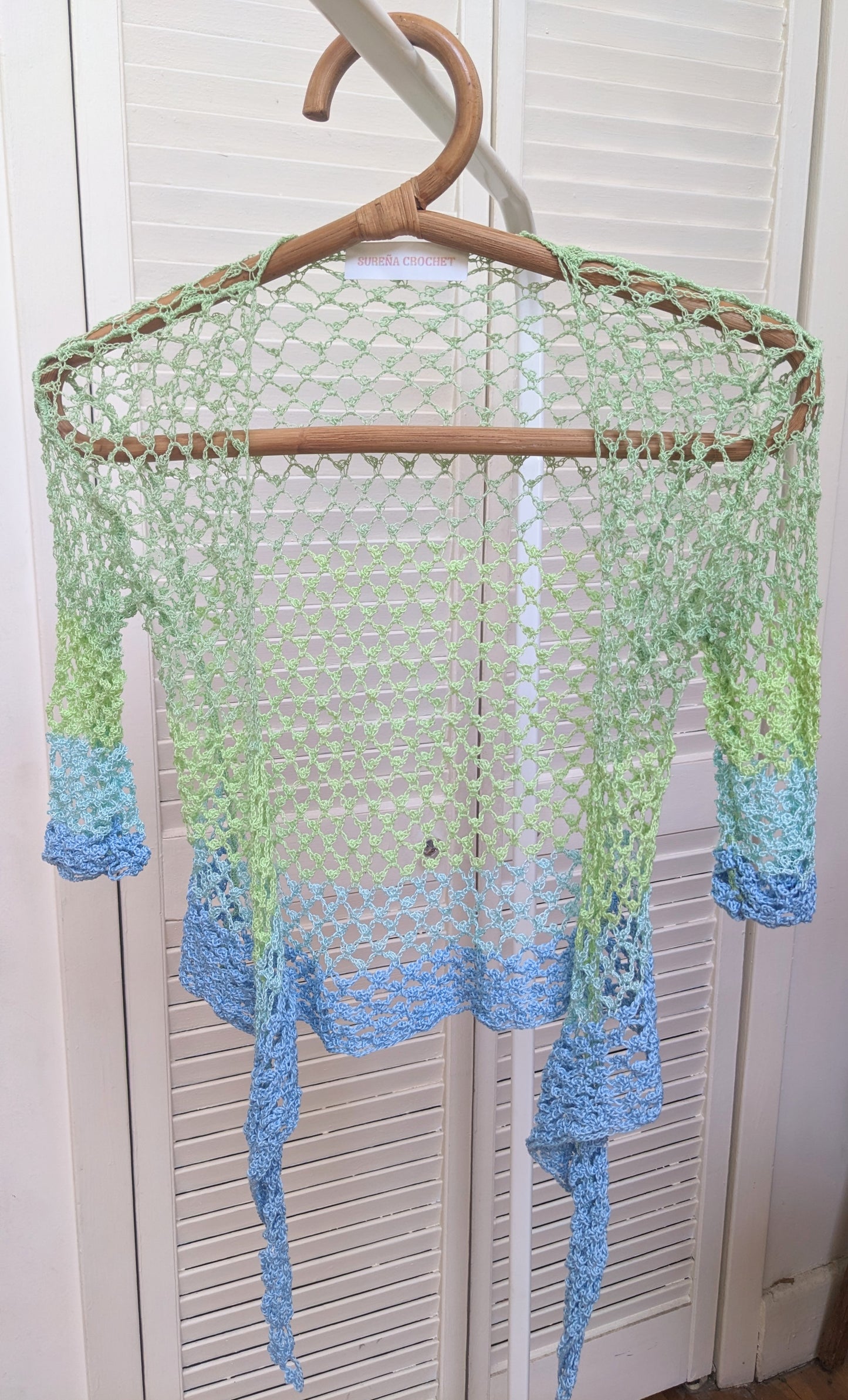 Detail of the surena crochet sirena crochet top in "ocean" blue and green color palette, handmade with cotton yarn