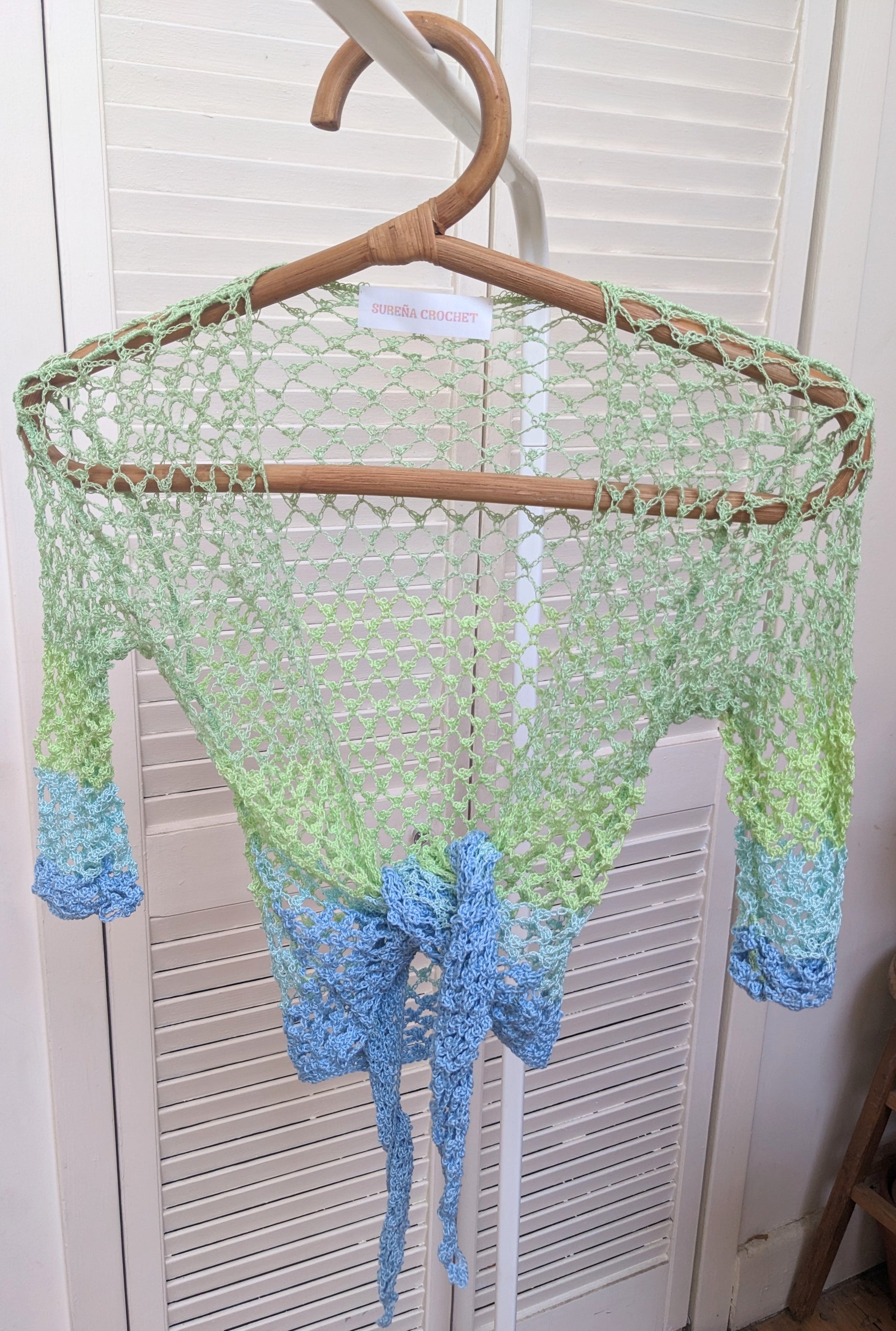 Detail of the surena crochet sirena crochet top in "ocean" blue and green color palette, handmade with cotton yarn