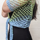 Model wearing the Surena crochet sirena crochet top in "ocean" blue and green color palette, handmade with cotton yarn