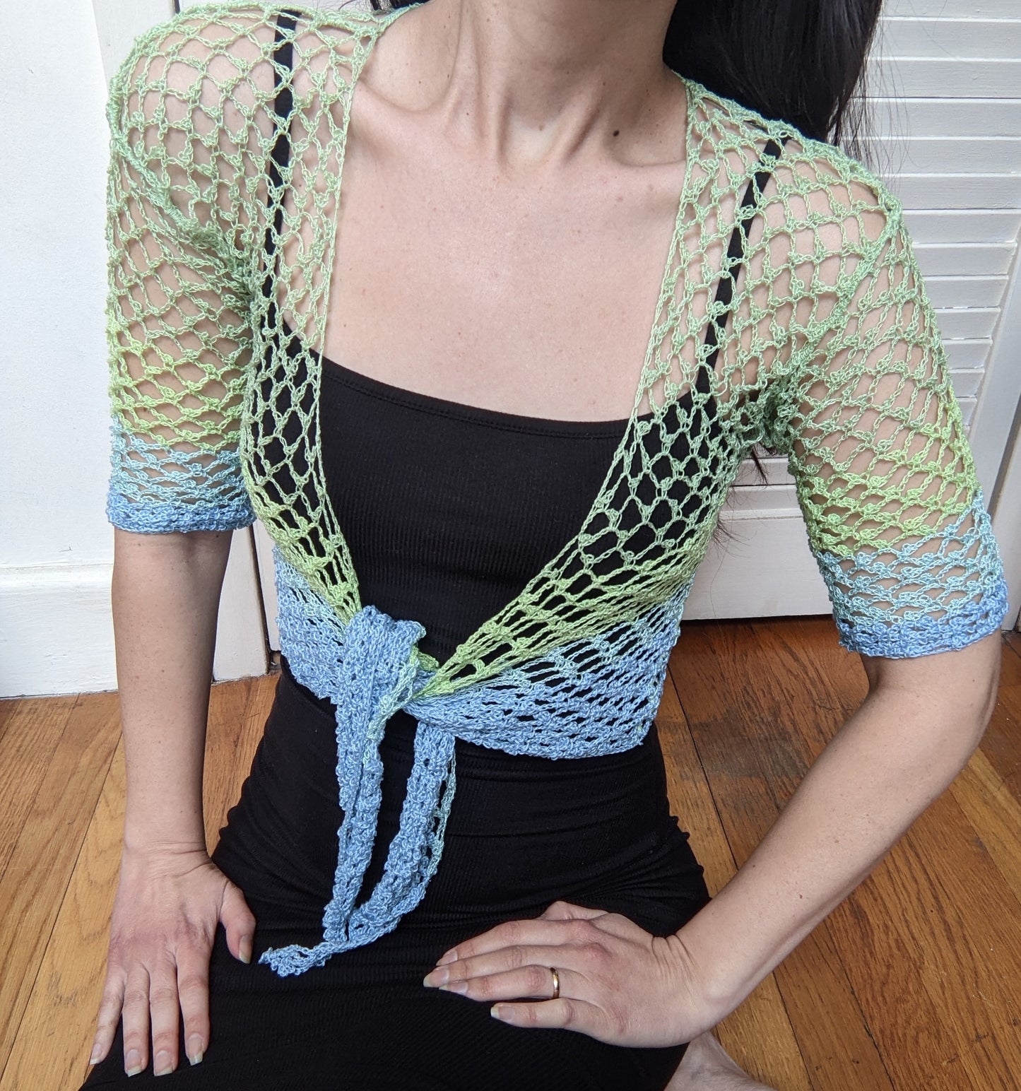 Detail of the surena crochet sirena crochet top in "ocean" blue and green color palette, handmade with cotton yarn