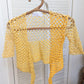Detail of the surena crochet top in "sunny" yellow color palette