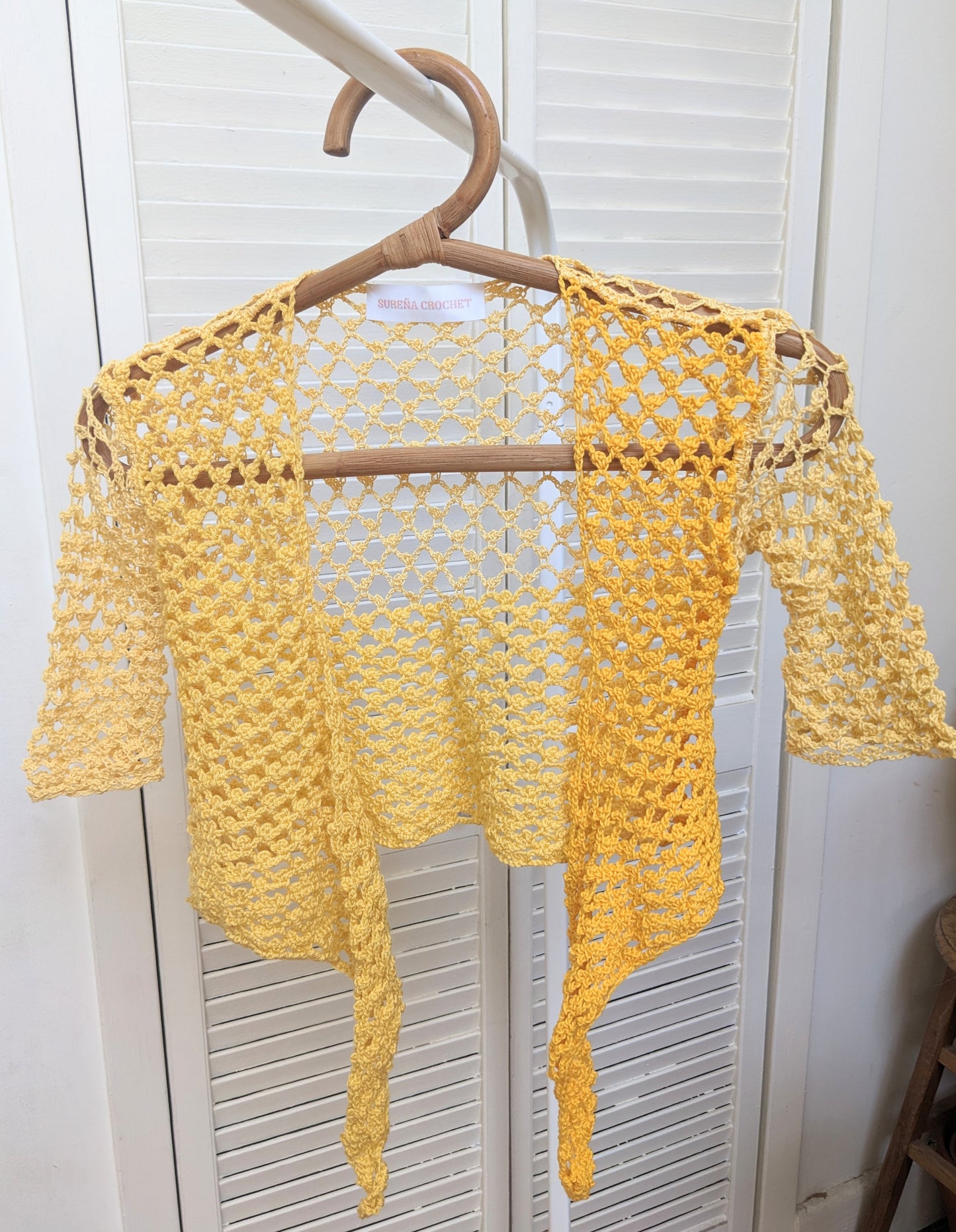 Detail of the surena crochet top in "sunny" yellow color palette