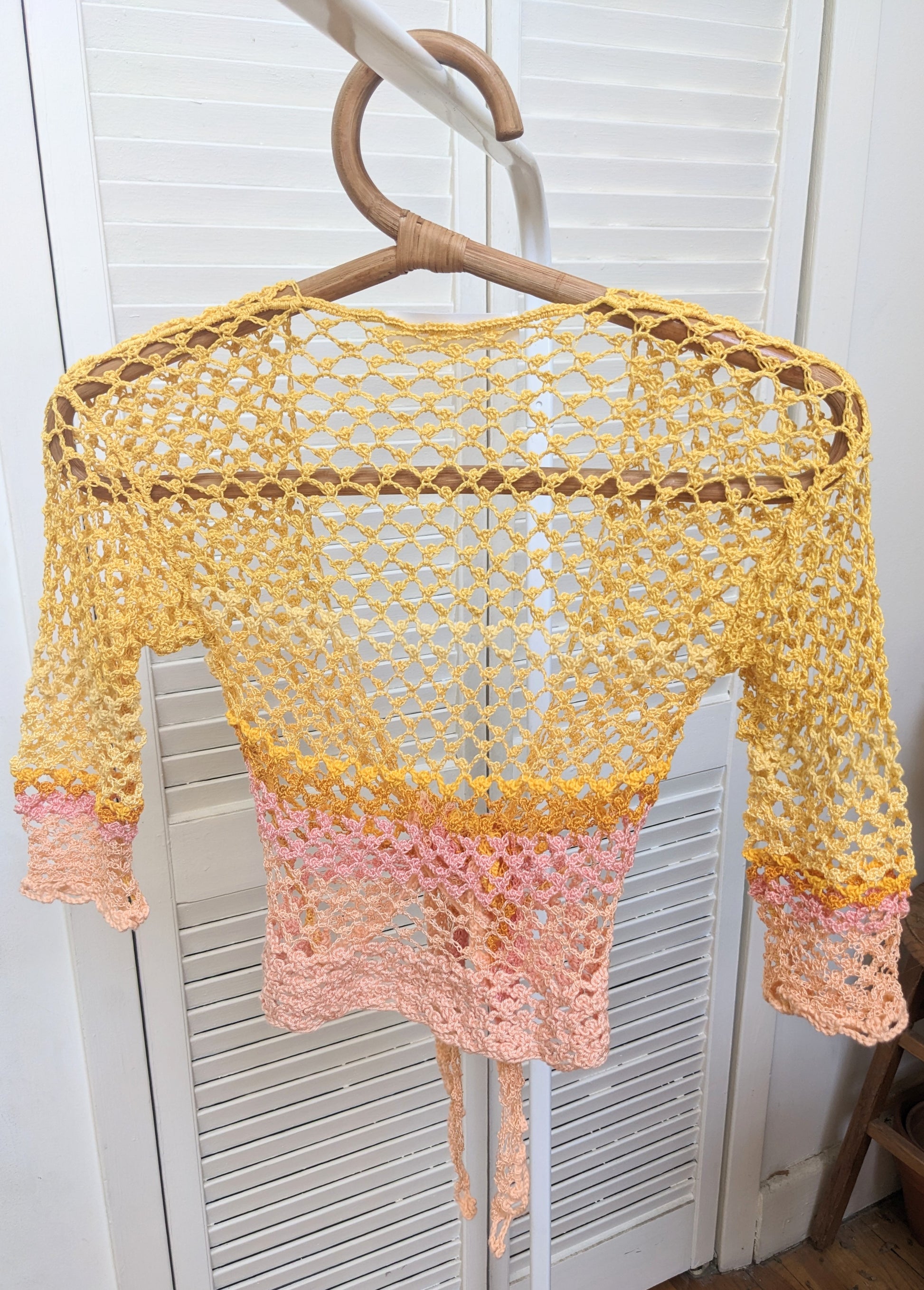 Detail of the Surena Crochet Sirena crochet top in "sunset" yellow and pink color palette