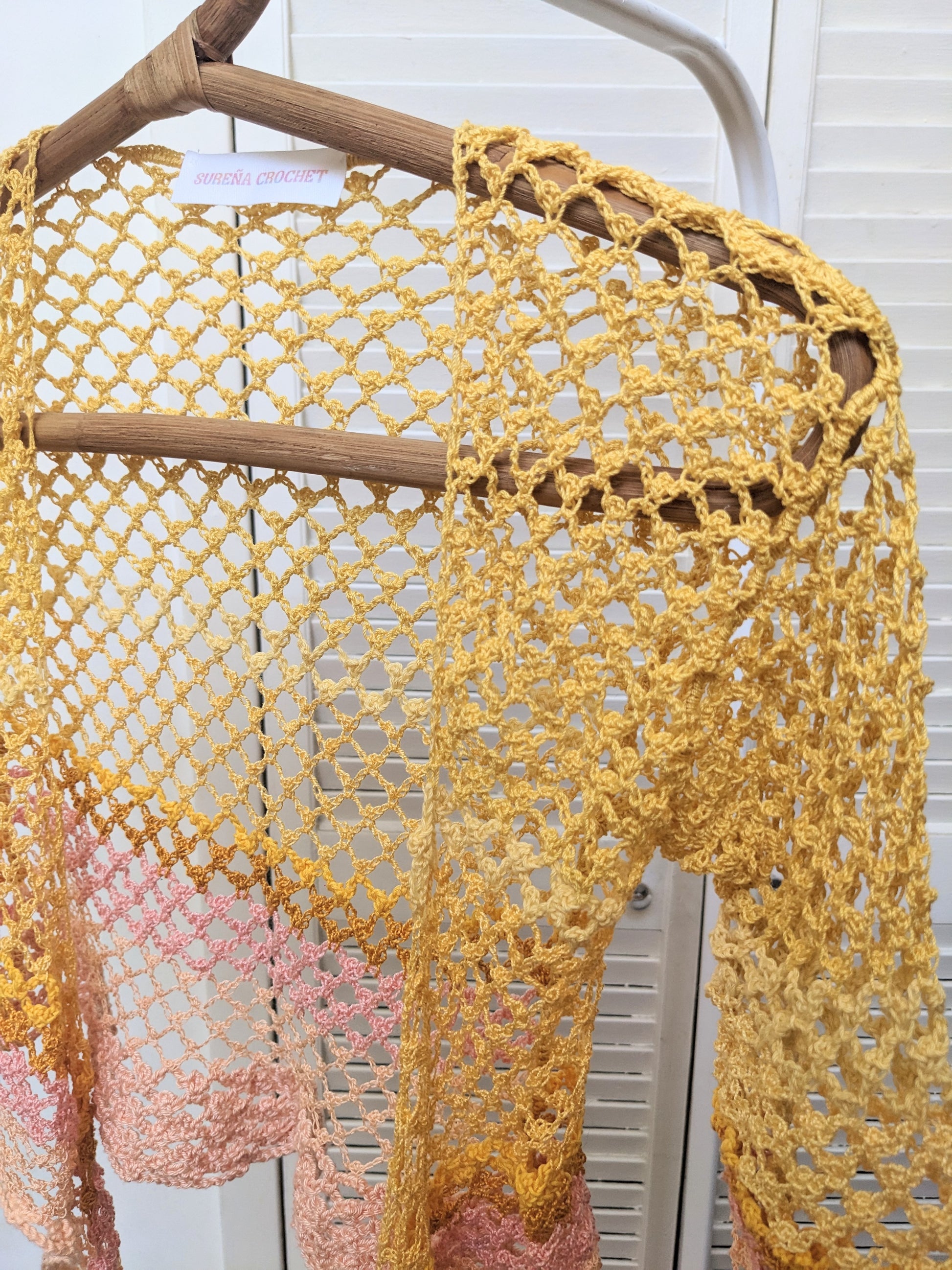 Detail of the Surena Crochet Sirena crochet top in "sunset" yellow and pink color palette