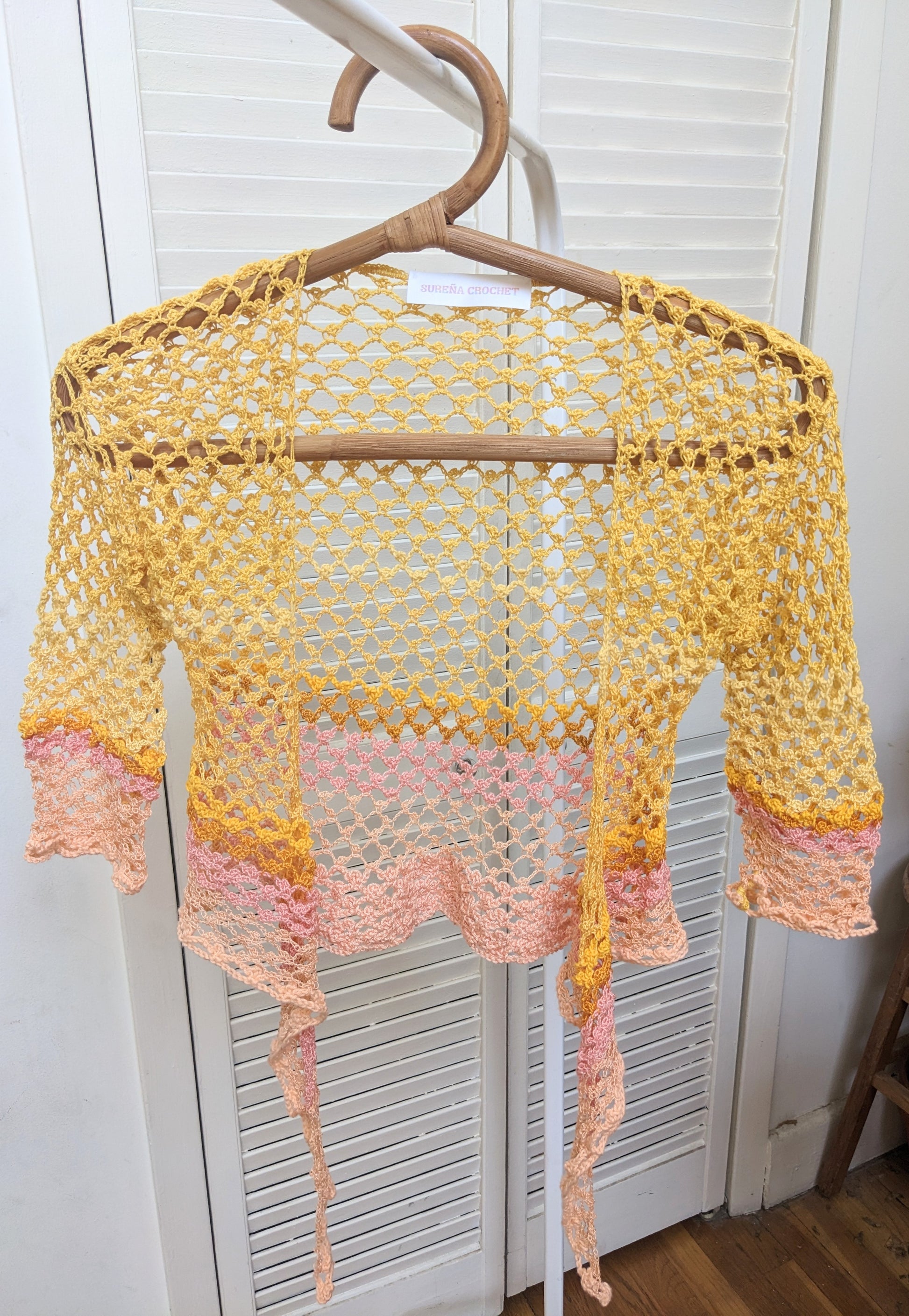 Detail of the Surena Crochet sirena crochet top in "sunset" yellow and pink color palette