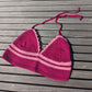 Surena crochet croptop handmade with fuchsia and pink cotton yarn, laid flat.