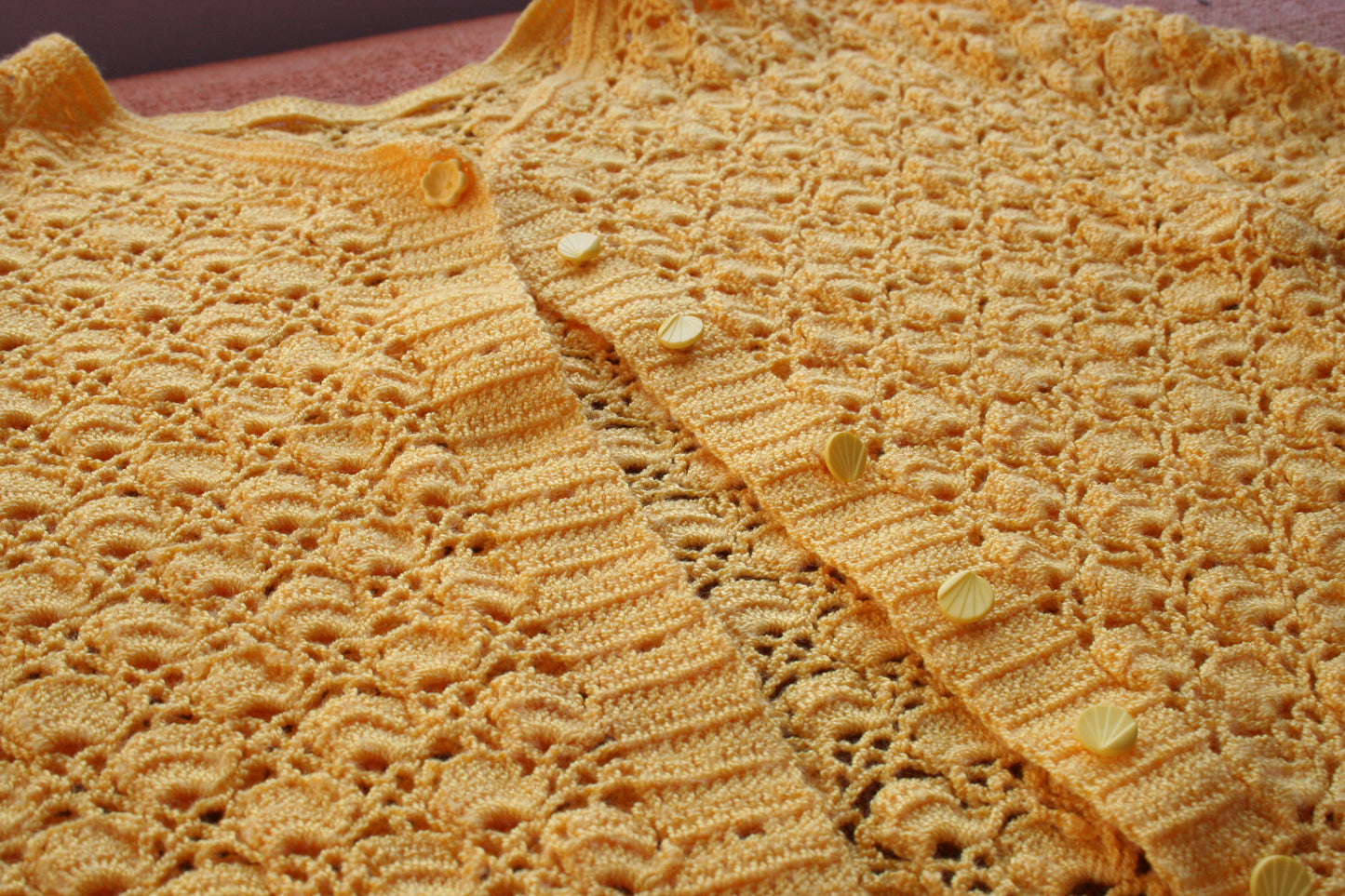 Detail of the crochet stitch pattern and buttons