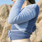 Model wearing the surena crochet ballerina wrap top in navy and baby blue, handmade crochet top made with cotton yarn.