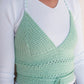 Model wearing the surena crochet margarita top in mint green, a handmade crochet top custom made with cotton yarn.
