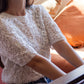 Model wearing the white crochet beaded shirt 