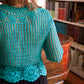 Back of the boho turquoise crochet vest, as worn by the model
