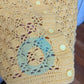 Detail of the small blemish on the Surena crochet "preloved" collection Sunshine yellow cardgian