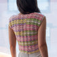 Back of the pastel rainbow crochet mini top, as worn by the model