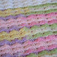 Detail of the crochet stitch pattern in the pastel rainbow mini top