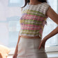 Model wearing the pastel rainbow crochet mini top