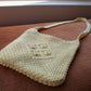 Second hand vanilla crossbody macrame bag laid flat 