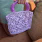 Detail of the surena crochet Jazmin bag, handmade with lilac raffia and using vintage handles.