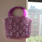 The Jazmín crochet raffia bag hung on the wall