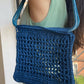 Model wearing the market raffia bag in blue 
